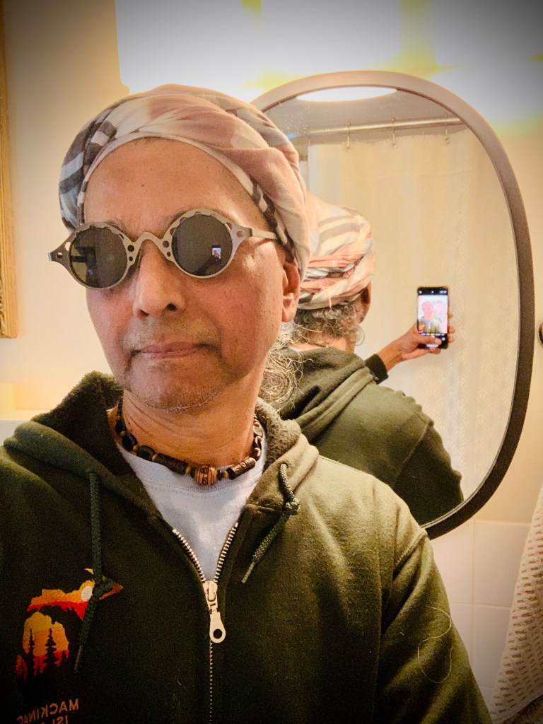 Ignatius taking a selfie after the head-wrap is done.