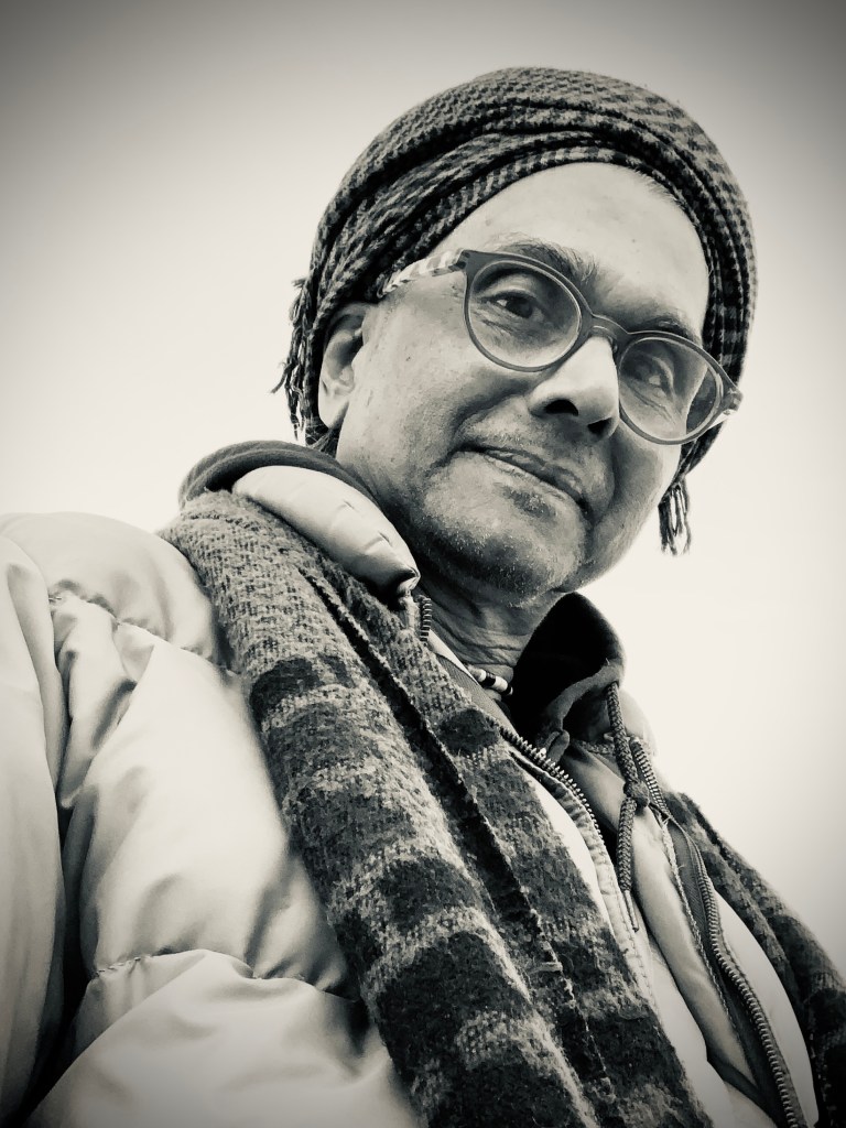 Black and white pic of Ignatius looking down and smiling